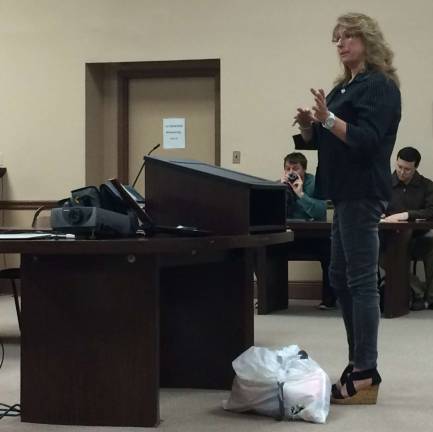 Photo by Diana Goovaerts Vernon resident Teresa Vihti expresses her concerns about excessive traffic on the Appalachian trail. Vihti brought in a trash bag filled with one day's worth of garbage left by hikers on her property.