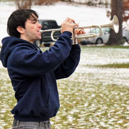 Vernon Township High School student Ian Donovan plays taps.