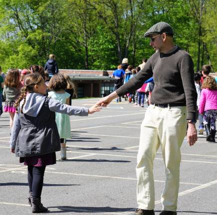 On right, Michael Moschella says goodbye to a student after the May Pole Dance.