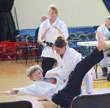Monica McGovern countering an attack by Cody Williams during a Self-defense demonstration at the Vernon Valley Karate Winterfest Tournament.