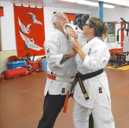 Sensei Monica McGovern demonstrates breaking out of an attacker’s grip with Sensei Tom Shull.