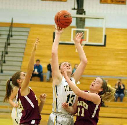 Vernon's Alicja Wesloske takes the ball towards the hoop during a shot.