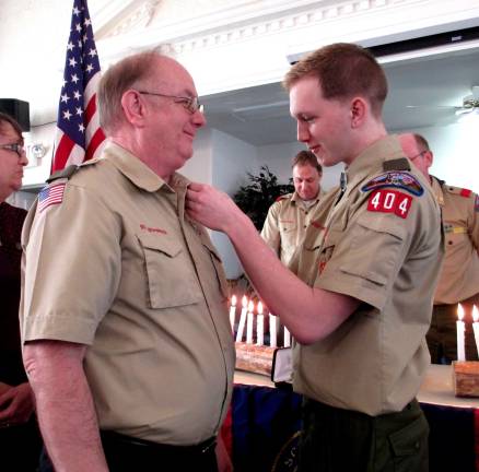 New Eagle scout Steven Schneider recognizes his father and assisant scoutmaster of Troop 404, Philip Schneider.