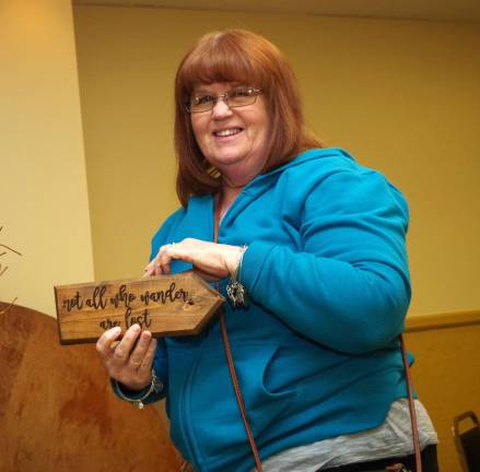 Wantage resident Jayne Squier of Harken Home retrieves a sign that says &quot;not all who wander are lost&quot; for a customer.