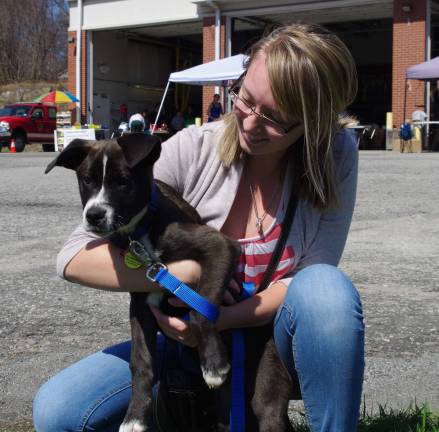 The day saw a steady stream of animal lovers including Vernon resident Kayla Walker who first played with and then adopted Porter, a male mixed breed puppy with webbed toes that indicate he has a good amount of water-type dog in him.