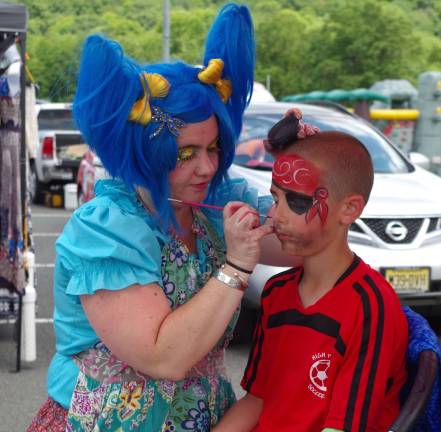Kerry &quot;Pixie Pop the Clown&quot; Tobin is shown giving High Point Soccer player Bradey Patrie, 7, of Sussex a pirate&#xfe;&#xc4;&#xf4;s face during Wantage Day held at Woodbourne Veterans Memorial Park.
