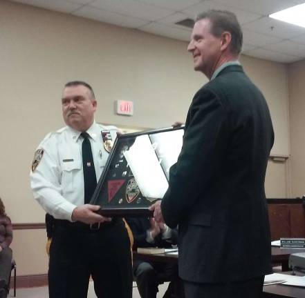 Vernon Police Chief Randy Mills honors Cpl. Ed Lazinski on his retirement.