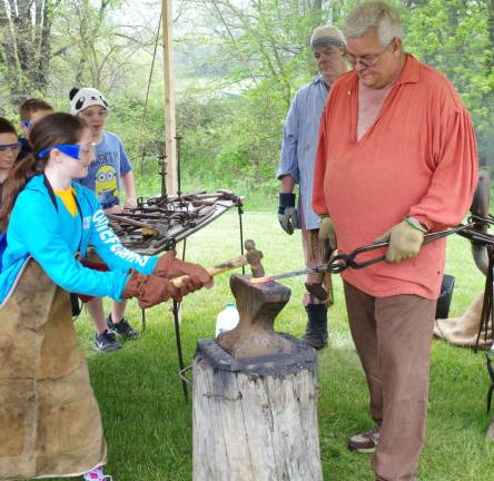 As his brother Brian kept the blacksmith&#xfe;&#xc4;&#xf4;s fire hot enough to soften iron, Jeff Dolan of Washingtonville, N.Y. taught the students about shaping iron to work as tools.