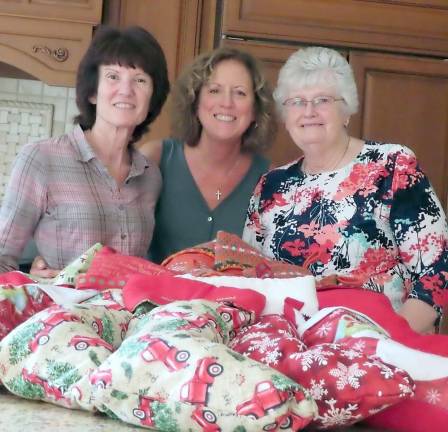 Goodies and personal hygiene supplies are stacked and ready to be stuffed into stockings for Operation Yellow Ribbon by members of the Vernon Township Woman's Club.