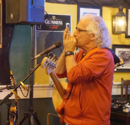 Ray Sikora plays the harmonica.