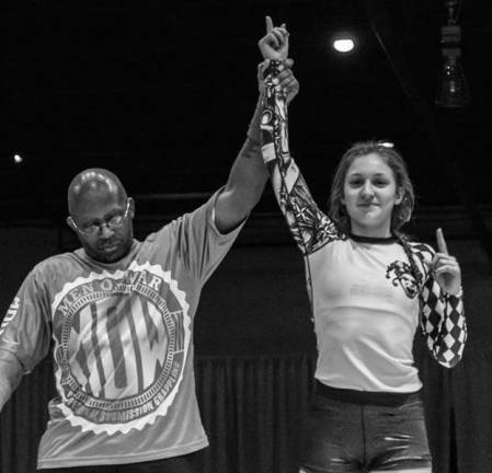 Brooke Fahey (right) gets her hand raised following her submission victory at Man of War 1