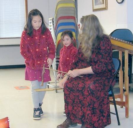 Audience volunteers help Linda Russell with making limber jack dance.