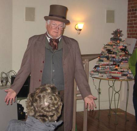 PHOTOS BY JANET REDYKEPaul Meacham portrays Ebenezer Scrooge in a reading of the Christmas Carol at the Black Dog Bookstore.