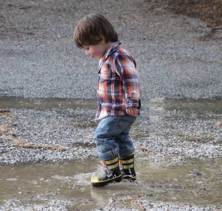 Little puddle jimper Sam Studley of Vernon enjoyed the rain at the rodeo.