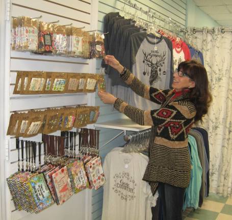 PHOTOS BY JANET REDYKE Rita Chimento, owner of Rainbow Reflections by Rita, adjusts some of the many sensory items in her shop.