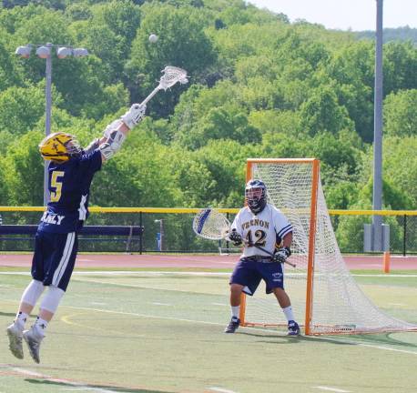 Jefferson's Ian Prezwodek leaps towards an overthrown ball from a teammate. Vernon Township High School defeated Jefferson Township High School (Oak Ridge, N.J.) in boys varsity lacrosse on Friday, May 19, 2017. The final score was 14-4. The quarterfinals of the North Jersey, Group 2 tournament took place at Vernon Township High School in Glenwood, New Jersey.