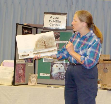 Avian expert Giselle Smisko of the Avian Wildlife Center reads the story Owl Moon to an interested group at the library.