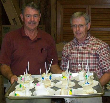 Barry Frint and Wayne Howell serve deserts at the Harvest Home Dinner.