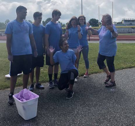 Teacher and National Honor Society advisor, Kathy Weyant prepares to toss some colored love onto some of the organizers of the Color Run