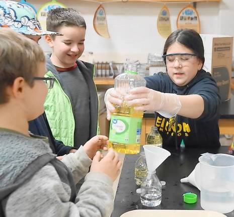 Students create water bottle lava lamps.