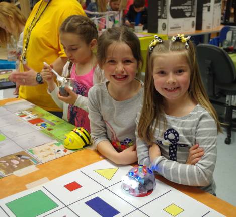 Walnut Ridge students Emma Casper, 6, and Kaitlyn Hordych, 7, were all smiles as they tried out an educational board game.