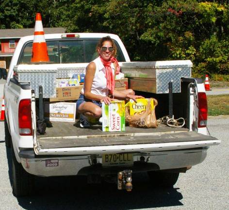 Lori Fitamant of Barry Lakes helped with loading the pickups with items collected during the Food Stock event held at Our Lady of Fatima Church.