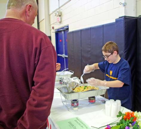 Ryan Spadafina, 13, of Vernon serves up some delicious samplings from the Irish Cottage Inn of Franklin and Cravin Thai of Hamburg.