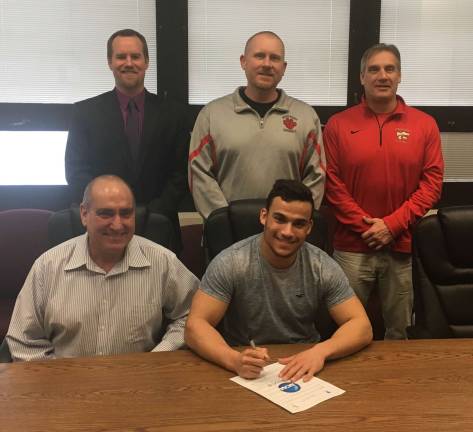 letter signing High Point's Jake Philip, seated with father Steven, will continue his football career next season at Salisbury University. Looking on in the back row from left to right are: Principal Jon Tallamy, Head Football Coach Jim Delaney, and Athletic Director Todd Van Orden.