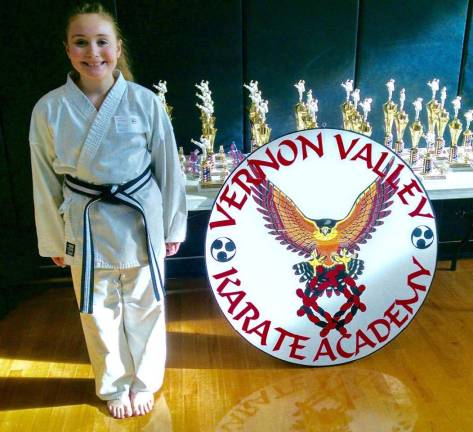 Gracie Doumanis waiting to receive her trophy at the Vernon Valley Karate Winterfest Tournament.
