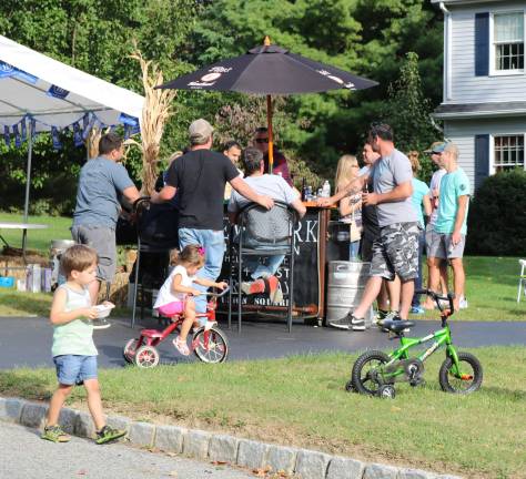 PHOTOS BY MARK LICHTENWALNERThe children play while the neighbors mingle at the bar.