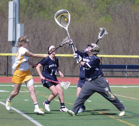 Pope John goalie Kayla Brutosky intercepts the ball preventing a Vernon score.