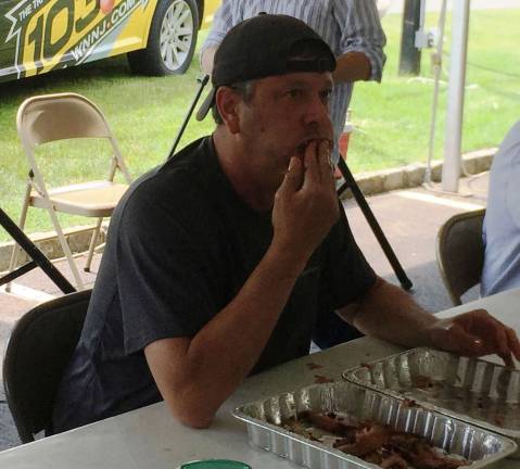 Andy Garger of the Sparta Education Foundation in Sparta, NJ won the 7th annual Rock, Ribs &amp; Ridges &#xfe;&#xc4;&#xfa;Rib Eating Challenge&#xfe;&#xc4;&#xf9; on Saturday, June 10 held at Franklin Sussex Auto Mall in Sussex. Garger downed a full rack of ribs in 4 minutes 11 seconds to beat out contestants from six other local non-profit groups in the annual fundraising event held by the upcoming Rock, Ribs &amp; Ridges music and food festival, June 24-25, at the Sussex County Fairgrounds and by festival presenting sponsor Franklin Sussex Auto Mall.