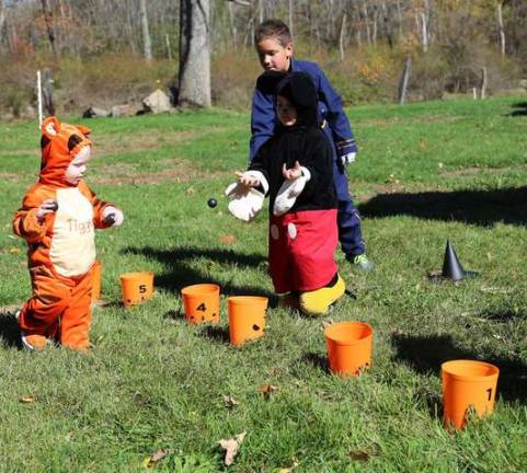 Children play the ring toss games at the DAR halloween party on Sunday.