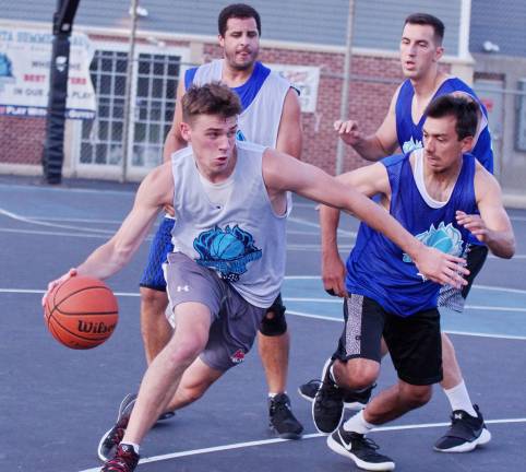 Team Smalley's Nick Lucas handles the ball while covered by Team Tobin's Zachary Frick.