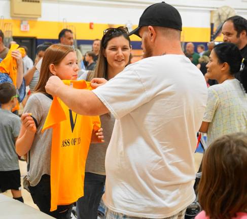 A family checks a sixth grader's Glen Meadow t-shirt