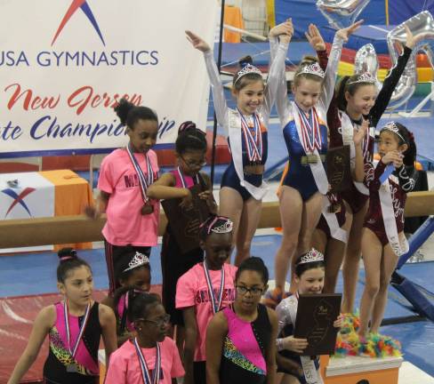 Giant Gymnastics athletes succeed at state meet New Jesey State champion bronze team of Fiona Postas, Cameron Volpe on the podium, and Kate Sutphen, below are shown.