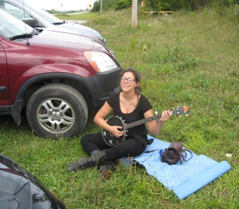 Banjo playing Lacey Liptack of Lafayette creates the mood with her bucolic strumming.