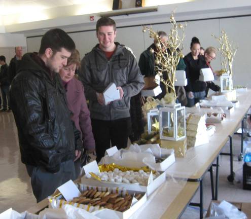 Cookie walk Christmas cookies are enticing the after church crowd at St. Francis de Sales Church benefiting Harvest House.