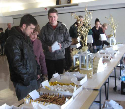 Christmas cookies are enticing the after church crowd at St. Francis de Sales Church benefiting Harvest House.