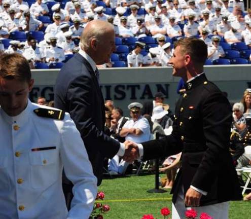 Vernon Township High School graduate is shown graduating from the U.S. Naval Academy in Annapolis, Md. He is shown shaking the hand of Vice President Joe Biden.