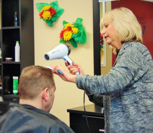 Owner Linda Tribuzio cuts a clients hair.
