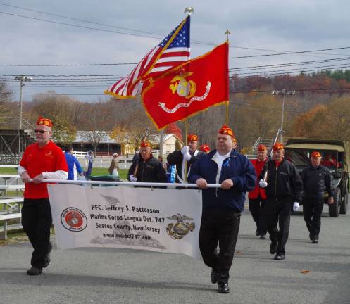 Sussex County veterans honored at fairgrounds Former Marines march in the parade.