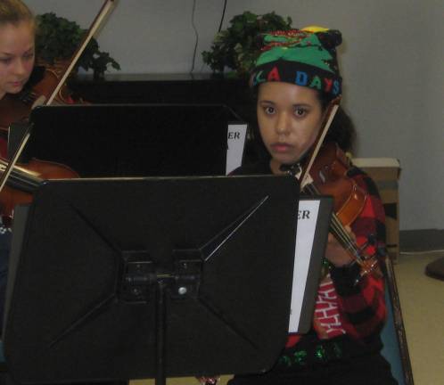 Violinist Nicole is holiday ready and concentrating deeply at the Dec. 20 concert.