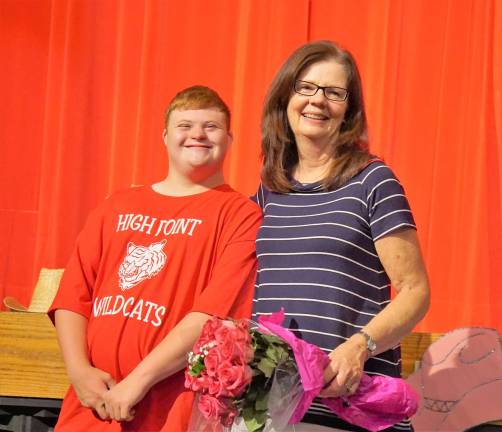 From left, Phil stands with teacher Joan Smith after the performance.