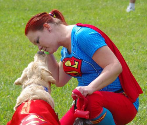 Visiting from Westtown, N.Y., Lynn Rhinesmith and her yellow lab Brodie wore &quot;super&quot; costumes and then competed in the Pucker-up contest.