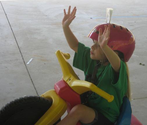 Upcoming kindergartners visit Safety Town A traffic and bike safety course rider admits his faux pas. Notice the traffic ticket in the helmet.