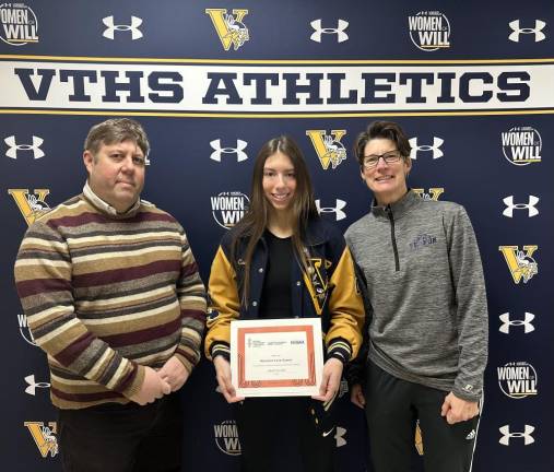 Senior Maryanna Cova-Gomez represents Vernon Township High School at National Girls and Women in Sports Day on Sunday, Jan. 21 at the Rutgers women’s basketball game. The event is hosted annually by the New Jersey State Interscholastic Athletic Association (NJSIAA). Cova-Gomez is a three-sport athlete (cross country, indoor track and softball). With her are head track coach Jim Saganiec and softball coach Kerry Ludeking.