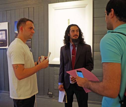 &quot;Supergood&quot; artists Johnny Moroz (left) and Garret Torres (center) talk about their creations during the opening event at Hamburg's Art Etc Gallery last Saturday evening.