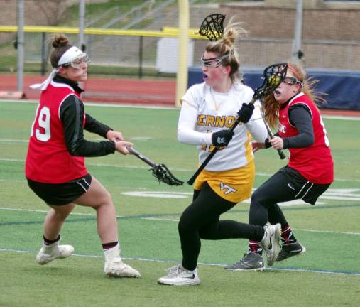 Lakeland defeats Vernon in girls lacrosse Vernon's Keirra Doyle carries the ball between two Lakeland defenders.
