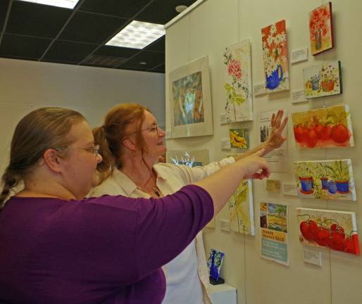 Jane Brennan, right, of Stillwater, talks about her artwork with Amanda Swentzel who works for the Sussex County Arts &amp; Heritage Council.